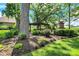 Secluded backyard featuring a custom pergola, outdoor fireplace, and lush landscaping at 8905 Stonebriar Dr, Indianapolis, IN 46259