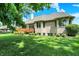 Well-kept backyard showing a brick home with a wood deck, showcasing the outdoor living space and landscaping at 8905 Stonebriar Dr, Indianapolis, IN 46259