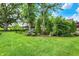 Expansive backyard featuring lush lawn, mature trees, and manicured landscaping adding beauty and privacy at 8905 Stonebriar Dr, Indianapolis, IN 46259