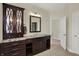 Bathroom boasting a granite countertop, a dark wood vanity, and a modern mirror at 8905 Stonebriar Dr, Indianapolis, IN 46259