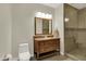 Bathroom featuring a wood vanity with a stone countertop and a tiled glass-enclosed shower at 8905 Stonebriar Dr, Indianapolis, IN 46259