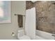 Bathroom with neutral-toned tile, a white shower curtain, and a tiled shower niche at 8905 Stonebriar Dr, Indianapolis, IN 46259