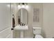 Clean and modern powder room with pedestal sink and decorative wall art at 8905 Stonebriar Dr, Indianapolis, IN 46259