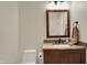 Modern powder room with custom vanity, elegant mirror, and contemporary fixtures at 8905 Stonebriar Dr, Indianapolis, IN 46259