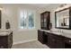 Elegant bathroom featuring dual vanities, granite countertops, and natural light from the window at 8905 Stonebriar Dr, Indianapolis, IN 46259