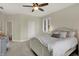 Comfortable bedroom offering plush carpet, a ceiling fan, a vanity and neutral walls at 8905 Stonebriar Dr, Indianapolis, IN 46259