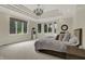 Bright bedroom boasts a tray ceiling, chandelier, and bay windows overlooking the lush outdoors at 8905 Stonebriar Dr, Indianapolis, IN 46259