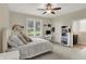 Cozy bedroom featuring plush carpeting, a comfortable bed, and a bright, airy ambiance at 8905 Stonebriar Dr, Indianapolis, IN 46259