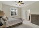 Comfortable bedroom featuring a ceiling fan, carpeted floor, and natural light from the window at 8905 Stonebriar Dr, Indianapolis, IN 46259