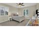 Elegant bedroom with large windows and shutters, soft carpet, and a ceiling fan at 8905 Stonebriar Dr, Indianapolis, IN 46259