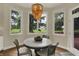 Breakfast nook featuring views of the yard, hardwood floors and beaded chandelier at 8905 Stonebriar Dr, Indianapolis, IN 46259