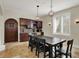 View of the dining area, featuring a rustic wood table set, wine bar and decorative pendant lighting at 8905 Stonebriar Dr, Indianapolis, IN 46259