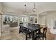 Open-concept dining area with access to the living room, showcasing pendant lights and a large table set at 8905 Stonebriar Dr, Indianapolis, IN 46259