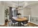Elegant dining room featuring a modern chandelier, stylish decor, and ample natural light at 8905 Stonebriar Dr, Indianapolis, IN 46259