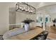 Bright dining room with wood floors, a modern chandelier, and views into the kitchen at 8905 Stonebriar Dr, Indianapolis, IN 46259