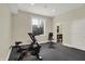 Dedicated exercise area with workout equipment, a window, and access to a sleek, modern bathroom at 8905 Stonebriar Dr, Indianapolis, IN 46259