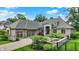 Stunning brick home featuring a stone entryway, lush landscaping, and an attached three-car garage at 8905 Stonebriar Dr, Indianapolis, IN 46259