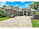 Gorgeous home with a paved circular driveway, a stone entryway, and lush landscaping at 8905 Stonebriar Dr, Indianapolis, IN 46259