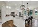Spacious kitchen with an island, stainless steel appliances, a gray backsplash, and hardwood flooring at 8905 Stonebriar Dr, Indianapolis, IN 46259