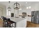 Stylish kitchen with white cabinets, stainless steel appliances, and a large island with barstool seating at 8905 Stonebriar Dr, Indianapolis, IN 46259