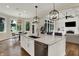 Bright kitchen featuring an island with seating, stainless steel appliances, and views of the backyard at 8905 Stonebriar Dr, Indianapolis, IN 46259