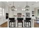 Modern kitchen featuring white cabinets, stainless steel appliances, and a large island with seating at 8905 Stonebriar Dr, Indianapolis, IN 46259