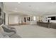 Expansive living room showcases open layout, access to the staircase, with contemporary furnishings at 8905 Stonebriar Dr, Indianapolis, IN 46259