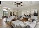 Open-concept living room featuring a fireplace, comfortable seating, and access to kitchen and dining room at 8905 Stonebriar Dr, Indianapolis, IN 46259