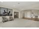 Spacious living area with neutral tones, stylish seating, and access to the staircase at 8905 Stonebriar Dr, Indianapolis, IN 46259