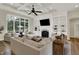 Spacious living room with a fireplace, built-in shelves, large windows, and coffered ceiling at 8905 Stonebriar Dr, Indianapolis, IN 46259