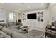 Cozy living room featuring a large sectional, custom built-ins, and a modern entertainment center at 8905 Stonebriar Dr, Indianapolis, IN 46259