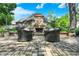 Inviting outdoor patio with a stone fireplace, comfortable seating, and landscaped surroundings for relaxing evenings at 8905 Stonebriar Dr, Indianapolis, IN 46259