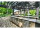 Backyard kitchen featuring stainless steel appliances, stone countertops, and convenient outdoor entertaining at 8905 Stonebriar Dr, Indianapolis, IN 46259