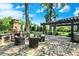 Outdoor space featuring a stone fireplace, comfortable seating, and a covered bar area for backyard entertaining at 8905 Stonebriar Dr, Indianapolis, IN 46259