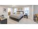 Well-lit bedroom with a black and white bedspread, a yellow throw pillow, and large windows providing natural light at 9234 Anthem Ave, Plainfield, IN 46168