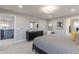 Bright bedroom with a patterned bedspread, black dresser, and views into other rooms, creating an open feel at 9234 Anthem Ave, Plainfield, IN 46168