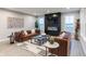 Elegant living room featuring a modern fireplace, stylish sofas, and an eye-catching area rug at 9234 Anthem Ave, Plainfield, IN 46168