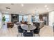 Spacious open concept living area with a modern fireplace, kitchen, and dining space at 9234 Anthem Ave, Plainfield, IN 46168