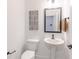 Compact powder room featuring a pedestal sink, modern fixtures, and decorative wall art at 9234 Anthem Ave, Plainfield, IN 46168