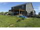 Backyard view of covered patio and fenced yard at 928 Cherry Tree Ln, Greenwood, IN 46143