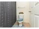 Cozy bathroom showcasing a toilet, shower curtain with a cute faux flower decoration at 928 Cherry Tree Ln, Greenwood, IN 46143