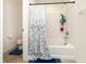 Clean bathroom showing a bathtub with a shower, and tile flooring at 928 Cherry Tree Ln, Greenwood, IN 46143