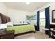 Bedroom with a green comforter, wooden headboard and a world map on the wall at 928 Cherry Tree Ln, Greenwood, IN 46143