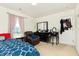 Cozy bedroom featuring a leather recliner and dresser with a mirror and makeup table at 928 Cherry Tree Ln, Greenwood, IN 46143