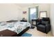 Bright bedroom featuring a comfortable recliner, large window, and neutral carpeting at 928 Cherry Tree Ln, Greenwood, IN 46143