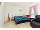 Bedroom with a patterned blue comforter and acoustic guitars adds a musical touch at 928 Cherry Tree Ln, Greenwood, IN 46143