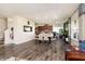 Open dining room featuring a large table set for six, flowing into a modern kitchen at 928 Cherry Tree Ln, Greenwood, IN 46143