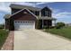 Two-story home with brick and siding, featuring an attached two-car garage and well-maintained front lawn at 928 Cherry Tree Ln, Greenwood, IN 46143