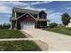 Two-story home with brick and siding, featuring an attached two-car garage and well-maintained front lawn at 928 Cherry Tree Ln, Greenwood, IN 46143