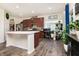 Well-lit kitchen with stainless steel appliances, island, and decorative plants at 928 Cherry Tree Ln, Greenwood, IN 46143